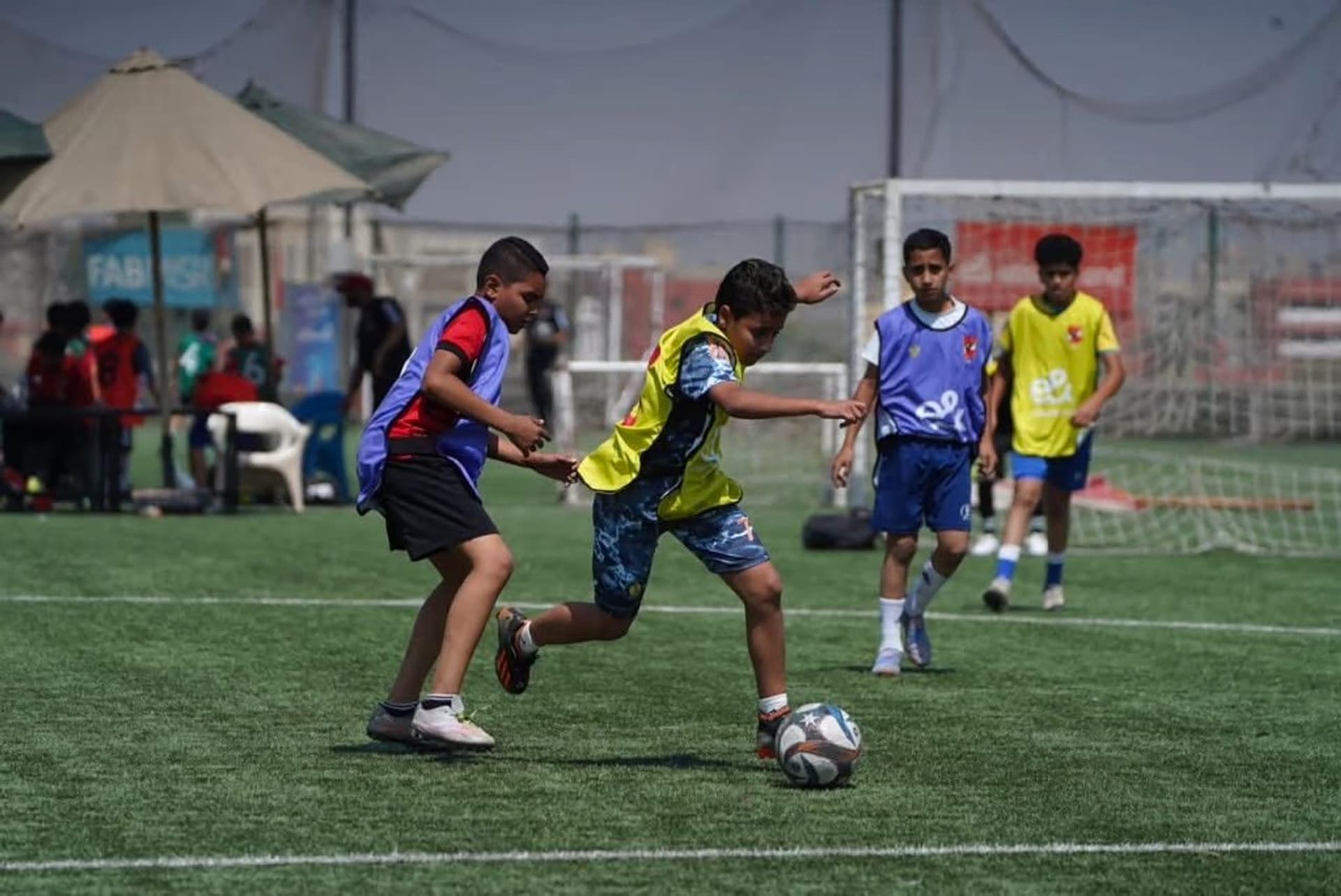 Youth players competing for the ball in training