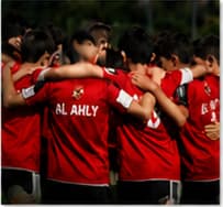 Al Ahly youth players in a team huddle